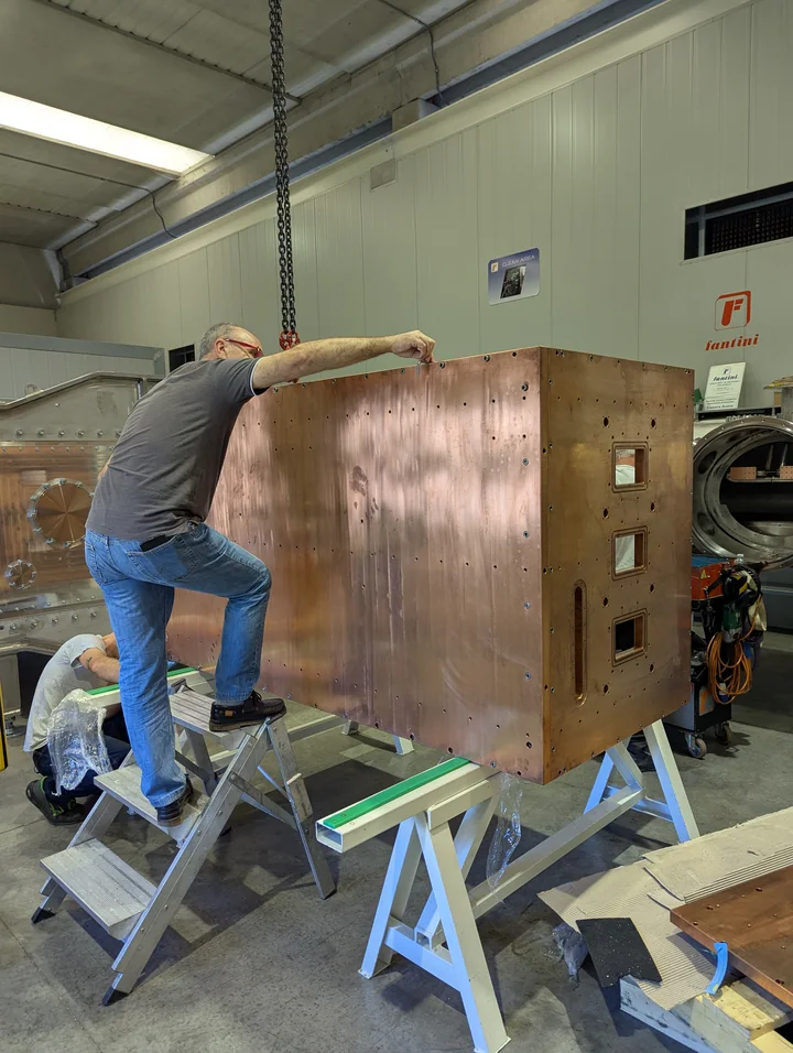 A technician assembling the copper vessel for CYGNO in a workshop