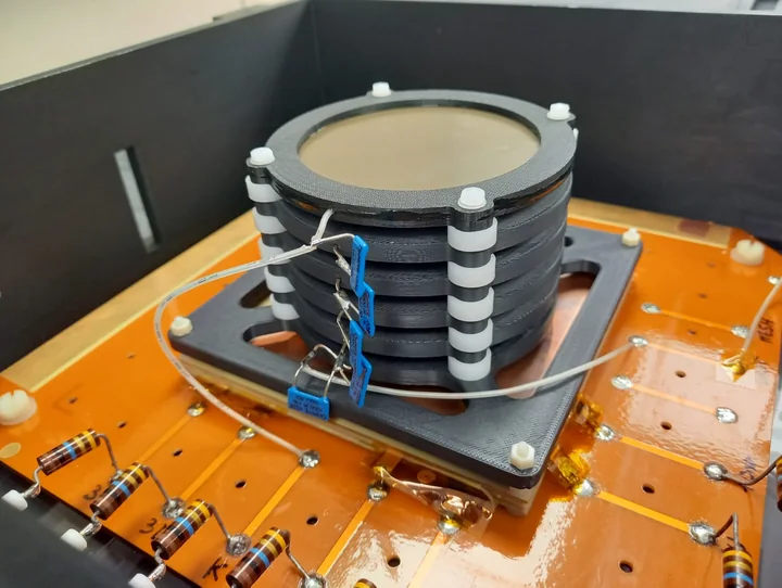Small cylindrical optical TPC prototype with stacked field-shaping rings mounted on a laboratory base