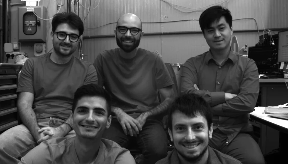 A small group of students and researchers together in the Gran Sasso school laboratory